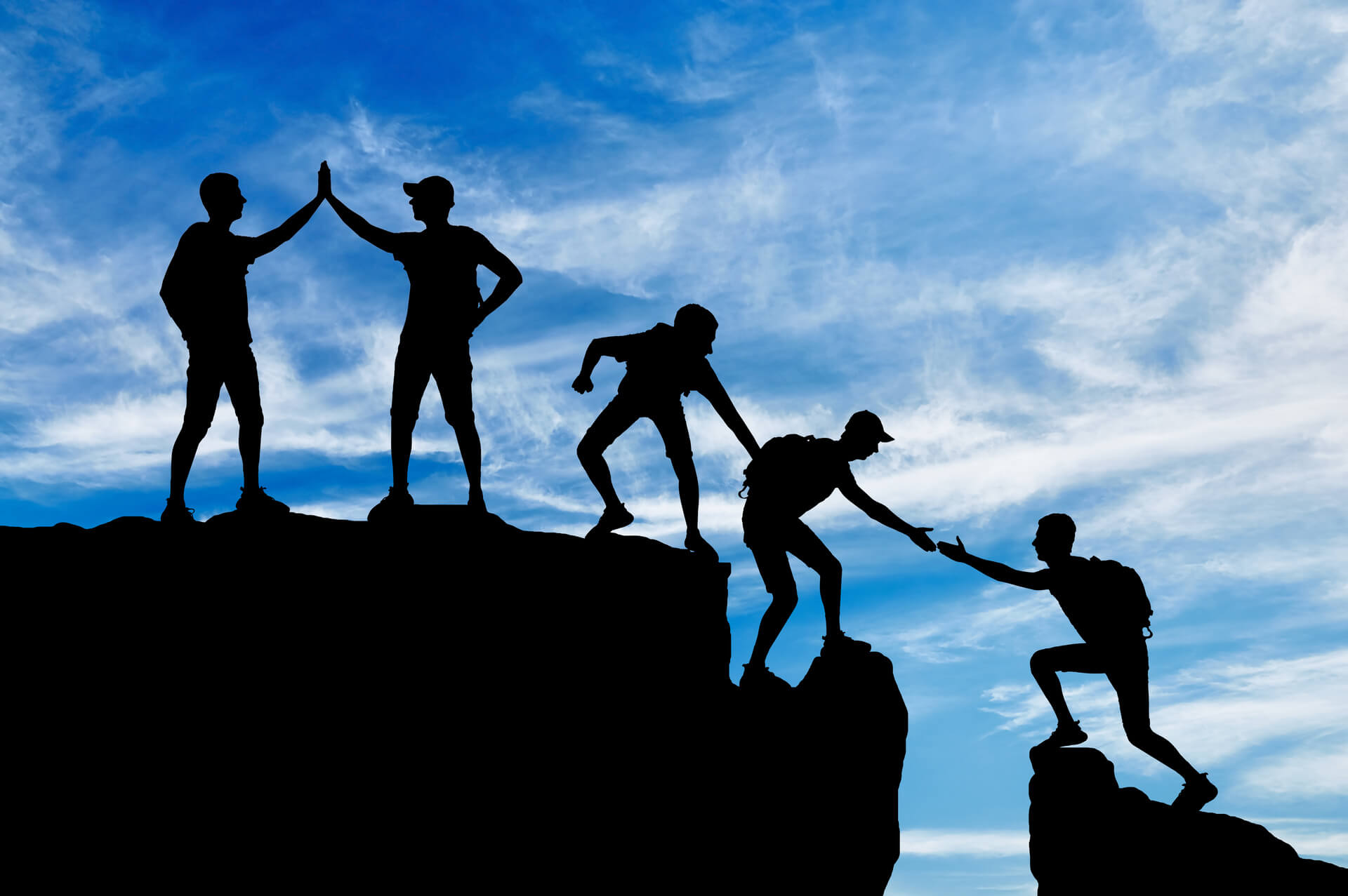 People helping each other on a mountain